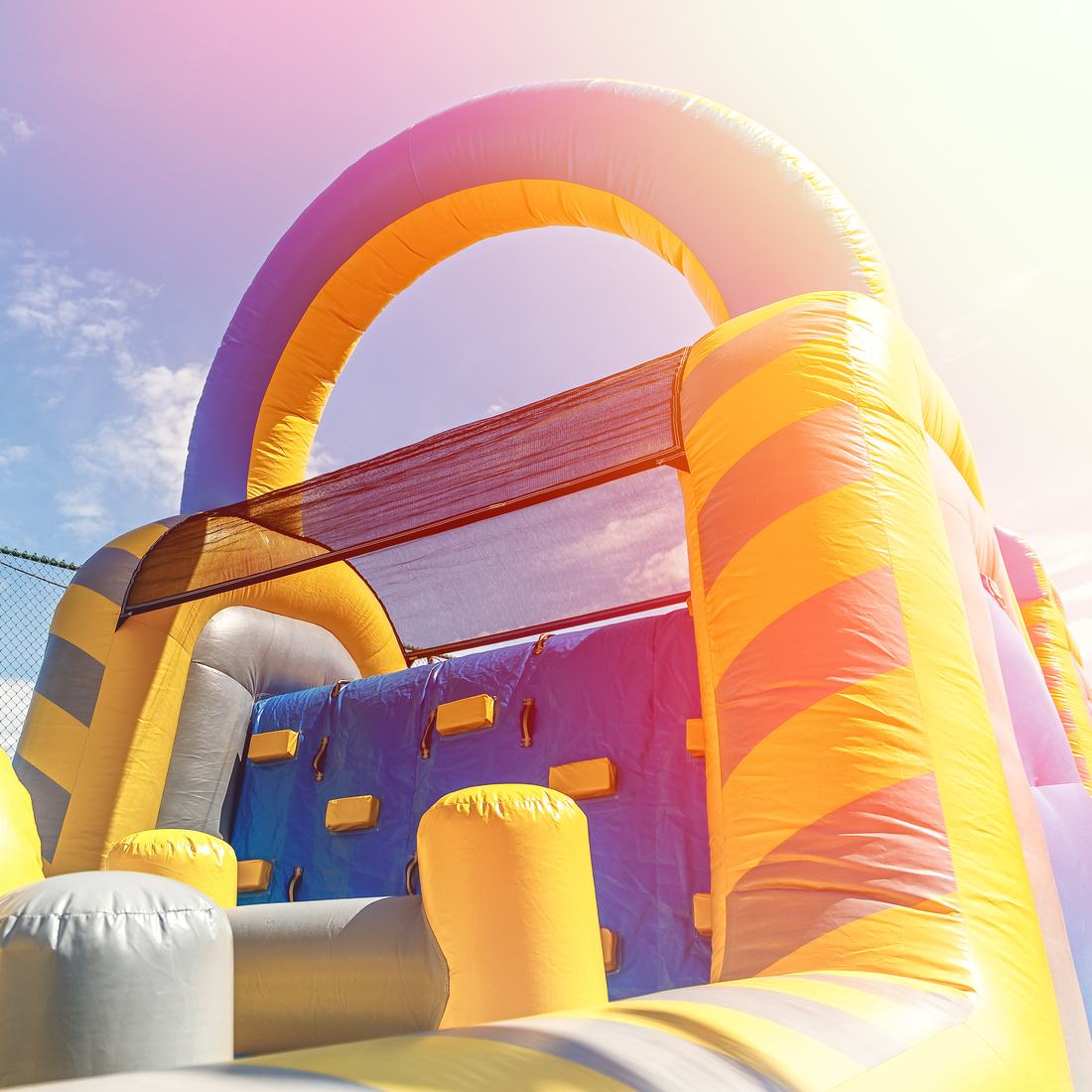 Inflatable climbing wall and arch glowing in afternoon sun